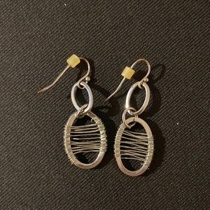 Silver dangle earrings with unique detail.